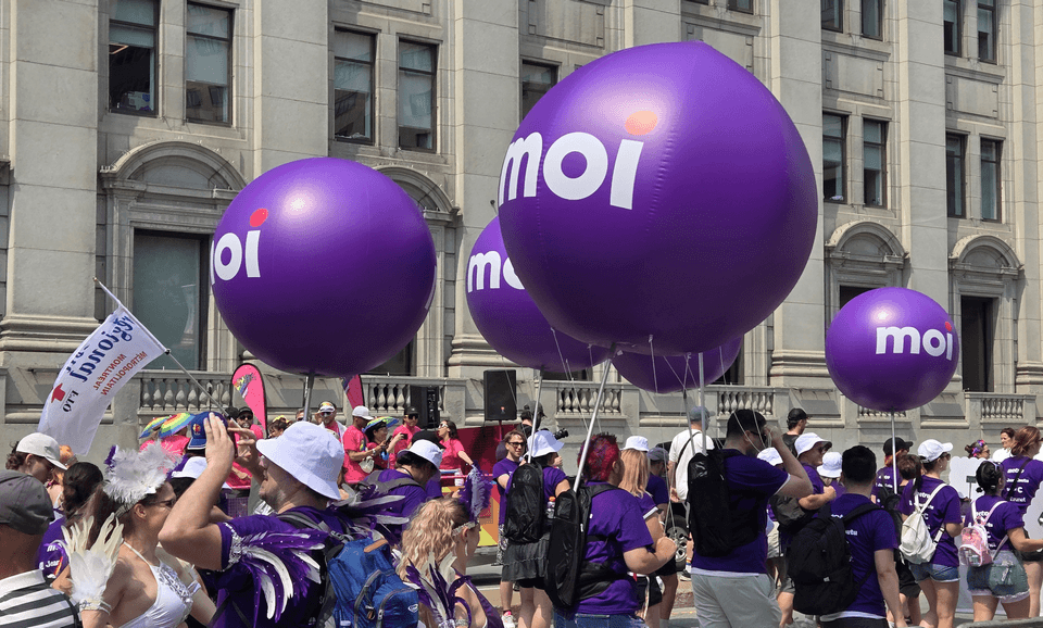 brand ambassadors walking in a parade with backpack balloons